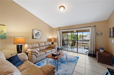 Living room featuring light tile patterned floors and high vaulted ceiling