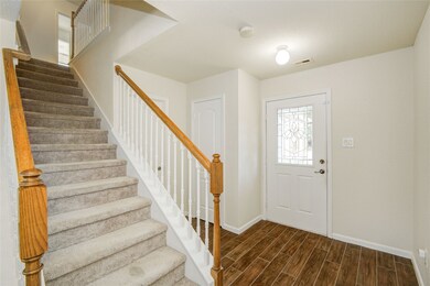 Step inside to a bright entryway with wood-look ti