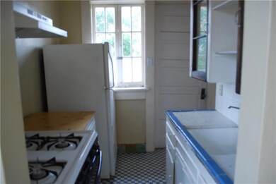 Cozy kitchen is furnished with a gas stove and a r