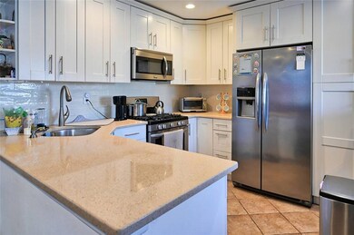Kitchen featuring light stone countertops, kitchen