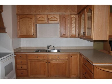 Updated kitchen features plenty of oak cabinets, d