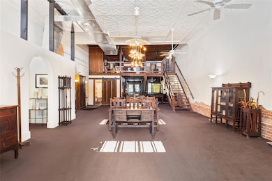 Dining area featuring arched walkways, ceiling fan