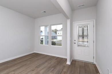 Foyer entrance with wood finished floors, baseboar