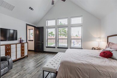 Come and unwind after a long day in this magnificent master suite! This spacious room features wood-like tile flooring, custom paint, high ceilings, dark stained ceiling fan with lighting and large windows.