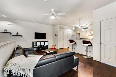 Living area with dark wood finished floors, ceili