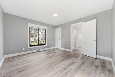 Empty room with light hardwood / wood-style flooring