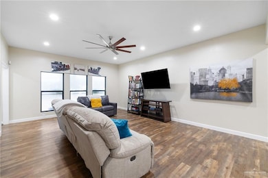 Living room featuring recessed lighting, wood finished floors, and ceiling fan