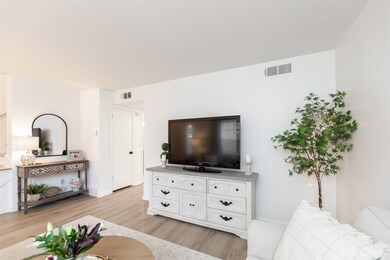 Living room with light hardwood / wood-style floor