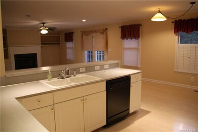 Kitchen overlooks living room, neutral colors