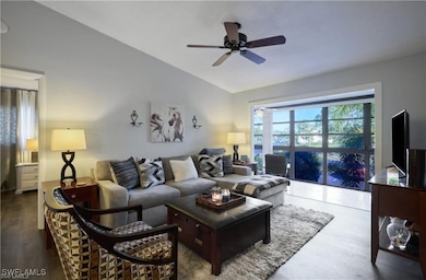 Living room featuring vaulted ceiling, ceiling fan