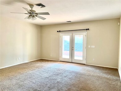 Carpeted spare room featuring french doors, ceilin