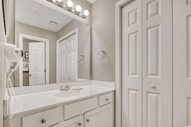 Bathroom featuring vanity, visible vents, and a cl
