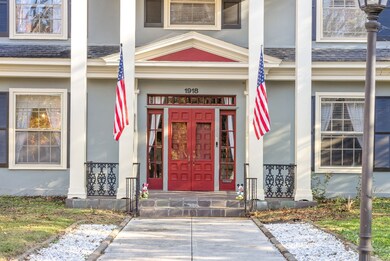 Inviting pathway entry with glorious columns and double doors