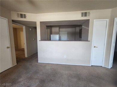 Carpeted spare room with baseboards