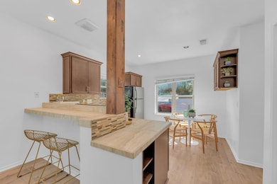 Kitchen featuring open shelves, freestanding refr