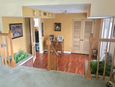 Large foyer entry: Go up three stairs to the living room or walk straight ahead to the den, fourth bedroom, main floor laundry, and bathroom.