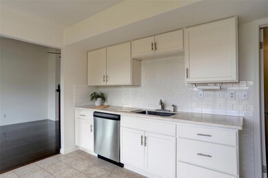 Kitchen featuring backsplash, dishwasher, and ligh