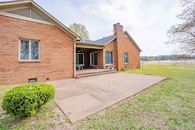 Rear view of property featuring crawl space, a law