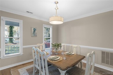 Dining area with dark wood-type flooring, ornament