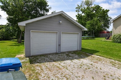 Detached garage featuring a trampoline