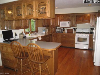 Custom built kitchen with breakfast bar and hardwood floors.