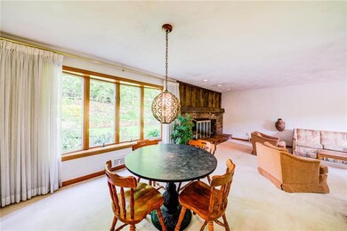 Dining room and living room have large bow windows