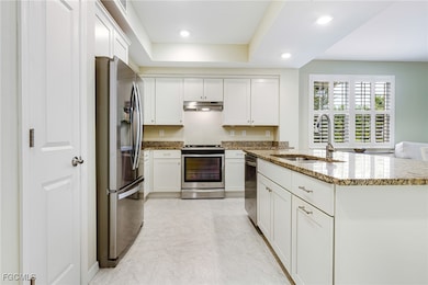 White shaker cabinets and granite countertops