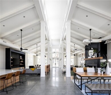 Dining area with decorative columns, lofted ceilin