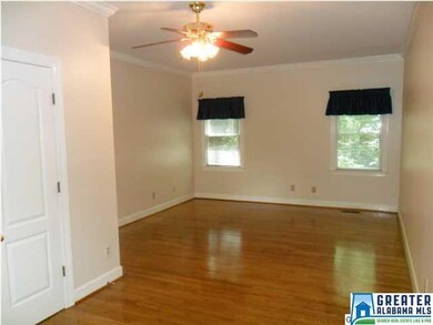 One of two main level bedrooms with hardwood floor