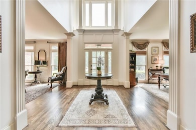 Entryway with ornate columns, a towering ceiling, 