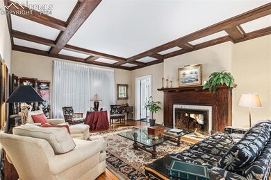 Living room with beam ceiling, hardwood / wood-sty