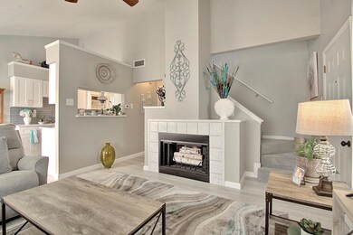 Living room featuring ceiling fan, vaulted ceiling