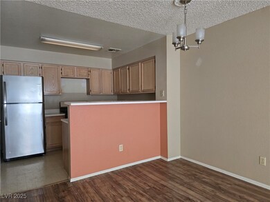 Kitchen with freestanding refrigerator, dark wood-