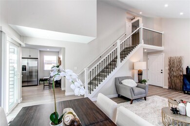 View of dining room to kitchen and upstairs.