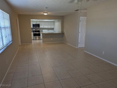 Unfurnished living room with a textured ceiling an