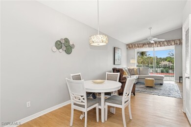 Dining area with ceiling fan, vaulted ceiling, and light hardwood / wood-style flooring