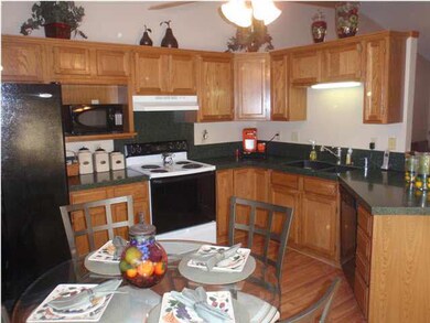 The kitchen features granite counter tops and wood