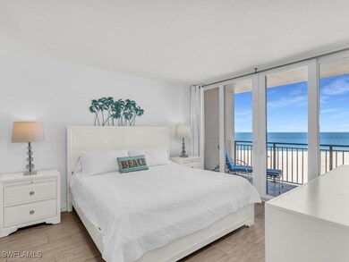 Bedroom featuring a beach view, a water view, acce