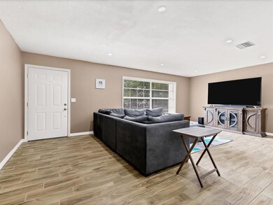 HUGE gathering room. Do notice the porcelain wood 