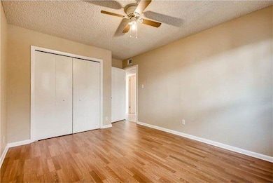 Unfurnished bedroom with wood finished floors, ba