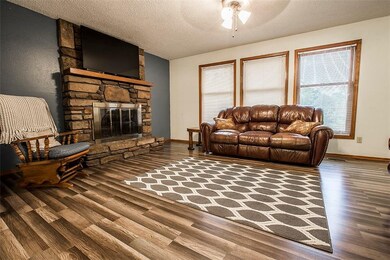 living room with windows looking out to the front yard