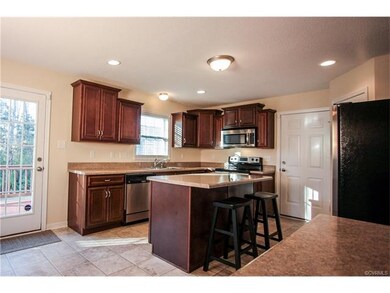 Kitchen with island, wood cabinets, stainless appl
