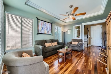 Living area featuring a raised ceiling, a ceiling