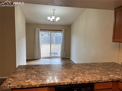 Unfurnished dining area with a textured ceiling an