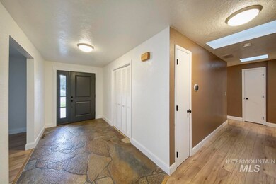 Foyer entrance featuring a textured ceiling and light wood-style flooring