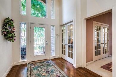 Looking back to the front door with gorgeous large windows. To the right is the formal dining, and a 2nd living/office space.