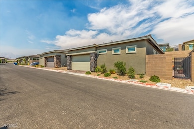 View of front of property with stucco siding, stone siding, a garage, and a gate
