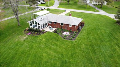 View of the rear of home, gorgeous flower beds and