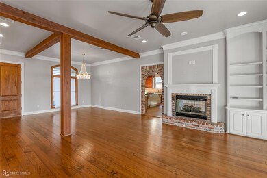 Formal living room featuring knotted pine wood flo