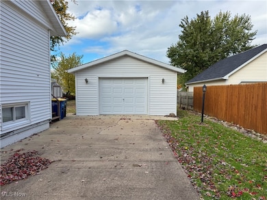 Detached garage with concrete driveway